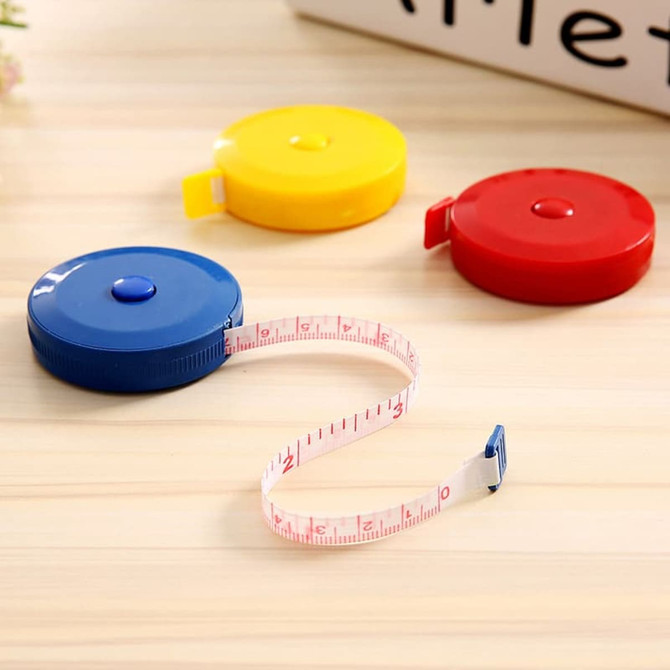 A set of three round tape measures in blue, red, and yellow, with a retractable measuring tape.