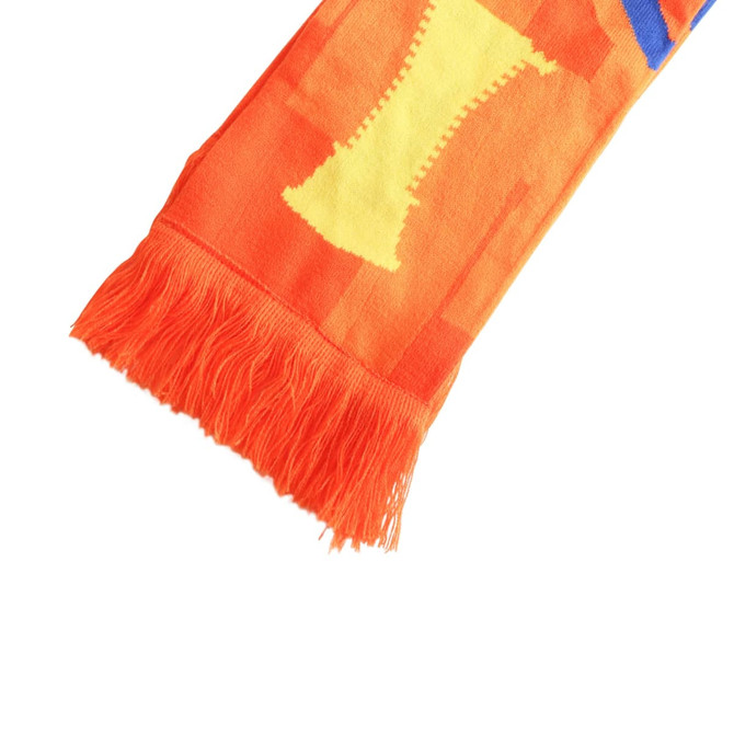 A vibrant orange scarf with yellow and blue patterns and fringed ends. It features a logo.