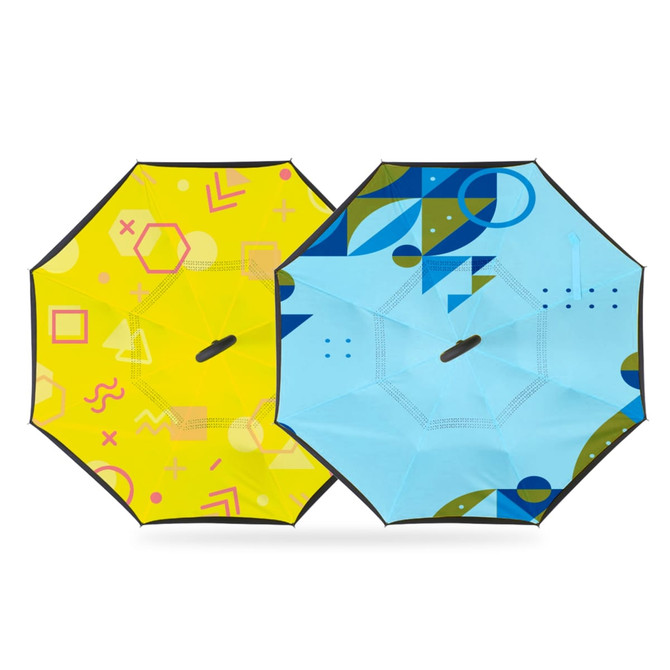 A reversible folding umbrella featuring a bright yellow side with geometric patterns and a blue side with abstract designs.