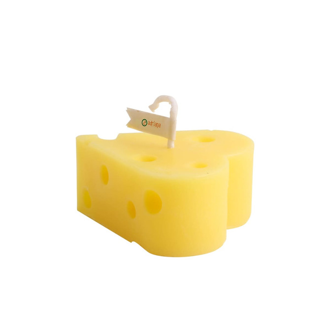 A yellow heart-shaped candle designed to resemble cheese, complete with a wick and a small tag.