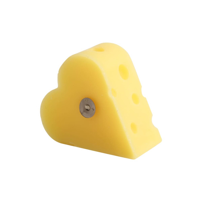 A heart-shaped yellow candle resembling a wedge of cheese, featuring holes and a silver base.