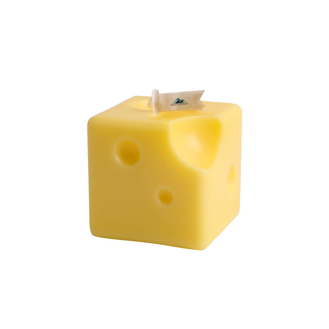 A square yellow candle shaped like cheese, featuring holes and a small flag.