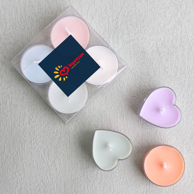 A tealight candle set in pastel colours, featuring heart-shaped candles in pink, blue, green, and purple, presented in a clear box.