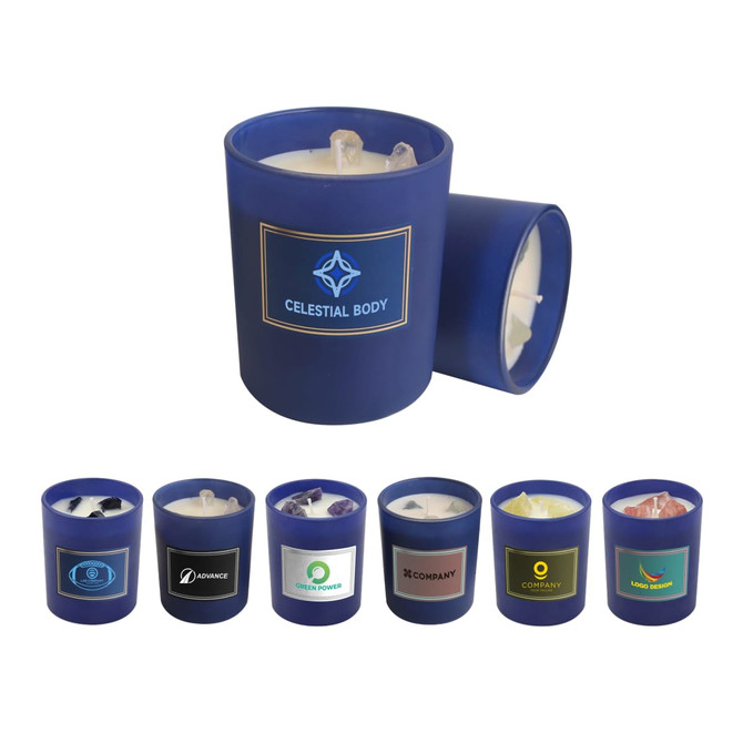 A 6.6oz blue glass candle with a white wax interior and gemstones on top, alongside various other candles in different colours.