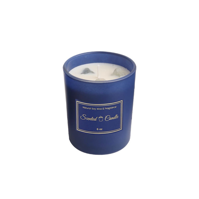 A blue glass candle with a white wax interior, featuring two wicks and a simple label.