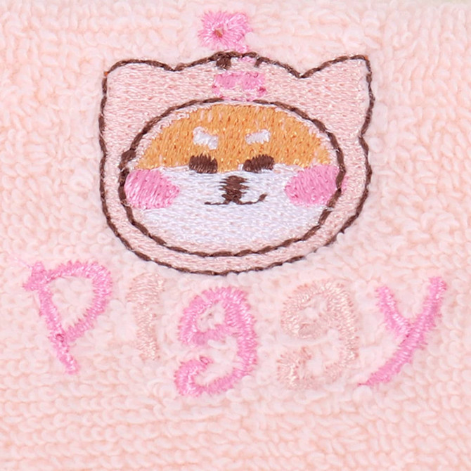 A soft pink towel featuring an embroidered cute piggy face and the word "piggy" in pink letters. A soft pink towel featuring an embroidered cute piggy face and the word "piggy" in pink letters.