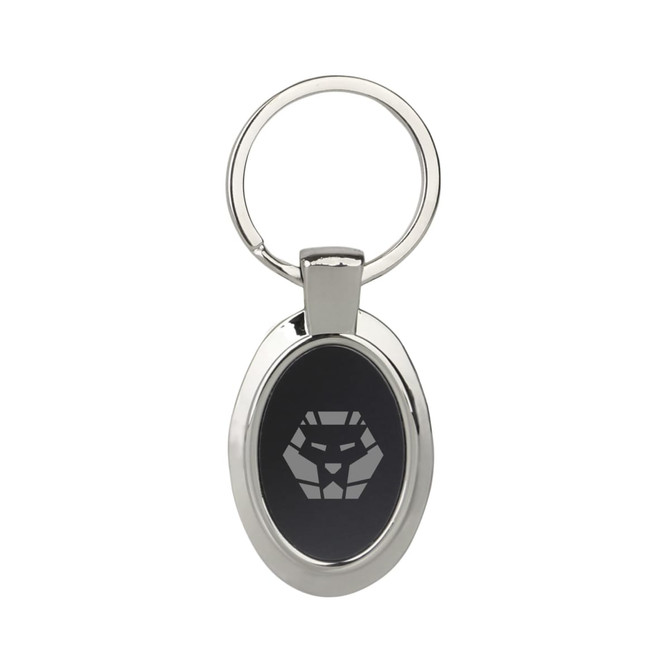 A silver keyring with an oval shape and a black panel featuring a logo design. A silver keyring with an oval shape and a black panel featuring a logo design.