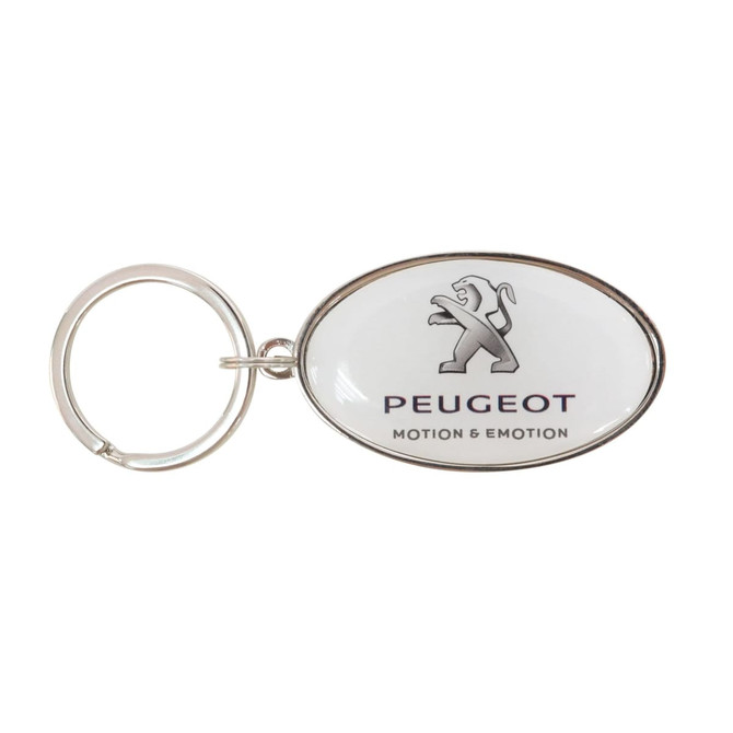 A silver oval keyring with a domed epoxy surface, featuring a logo and text on a white background.