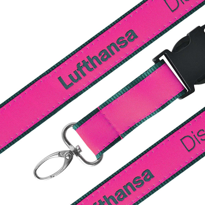 A detailed woven lanyard in vibrant pink with a green backing, featuring a clip attachment and a logo.