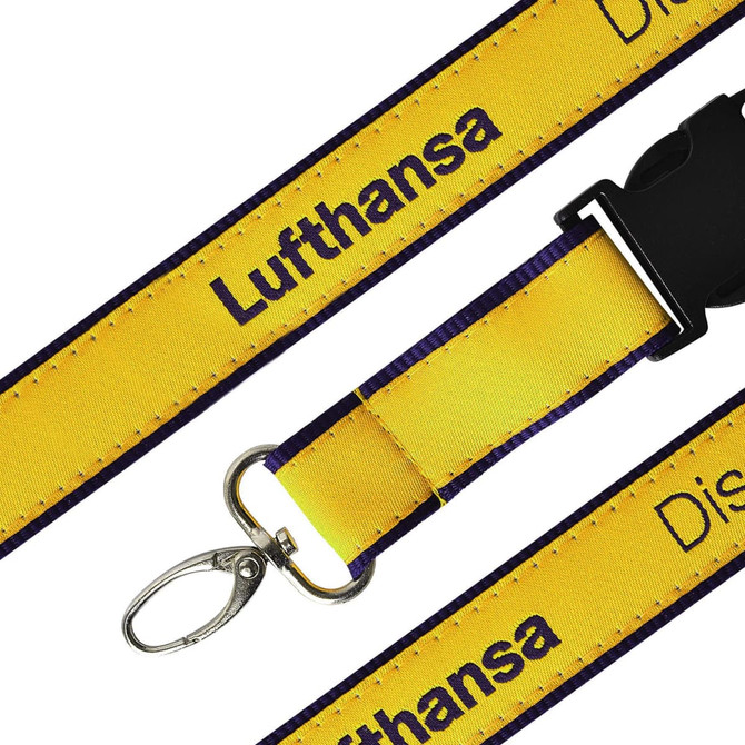 A detailed woven lanyard in yellow and purple with a clip and branding.
