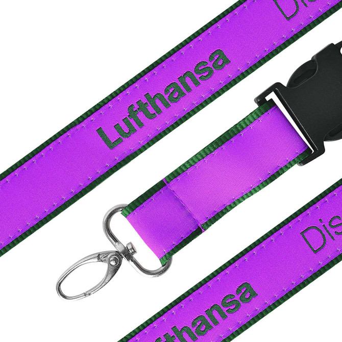 A purple woven lanyard with green edges featuring a clip for attaching items and a logo.