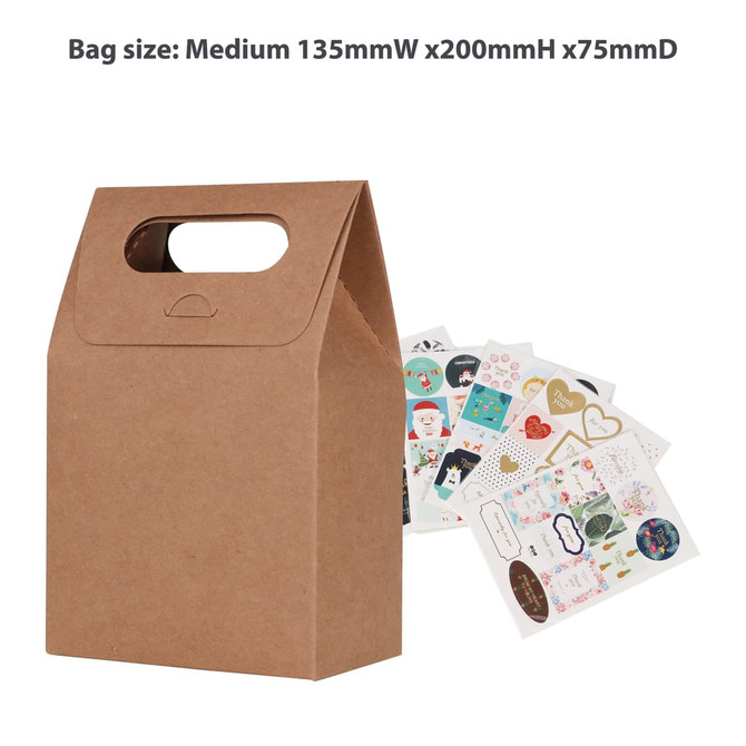 A medium brown die cut handle bag with a hold and a collection of assorted stickers nearby. A medium brown die cut handle bag with a hold and a collection of assorted stickers nearby.