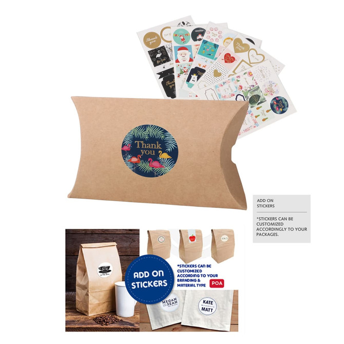 A small brown kraft pillow box featuring a round logo and assorted stickers placed behind it.