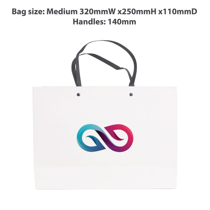 A medium white paper bag with a knitted black handle and a colourful logo on the front.
