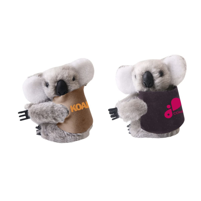 A cute grey plush koala toy with a coloured fabric pouch, featuring a logo. It has white ears and a friendly expression.