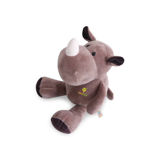 A grey plush toy rhinoceros with a white horn and dark brown accents, featuring a logo on its side.
