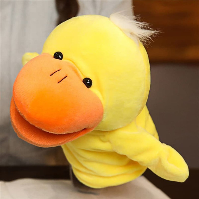 A plush duck hand puppet in bright yellow with an orange beak and black eyes, featuring a fluffy tuft on top.
