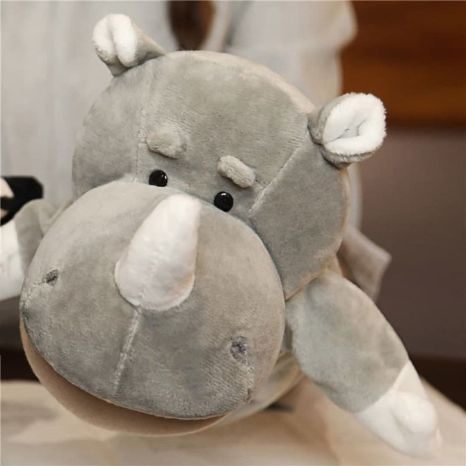 A plush grey rhinoceros hand puppet with small ears and a rounded snout, featuring black plastic eyes.