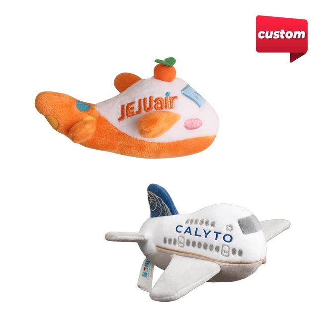Two custom plush airplane toys, one in orange and white with a citrus accent, the other in white and blue, featuring different designs.