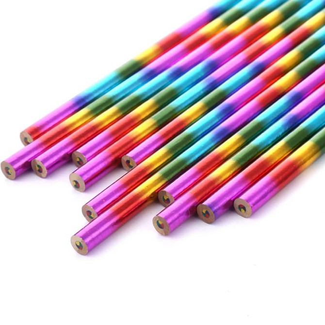 A set of long, vibrant four-colour pencils in shades of pink, blue, green, and gold, arranged in a group.