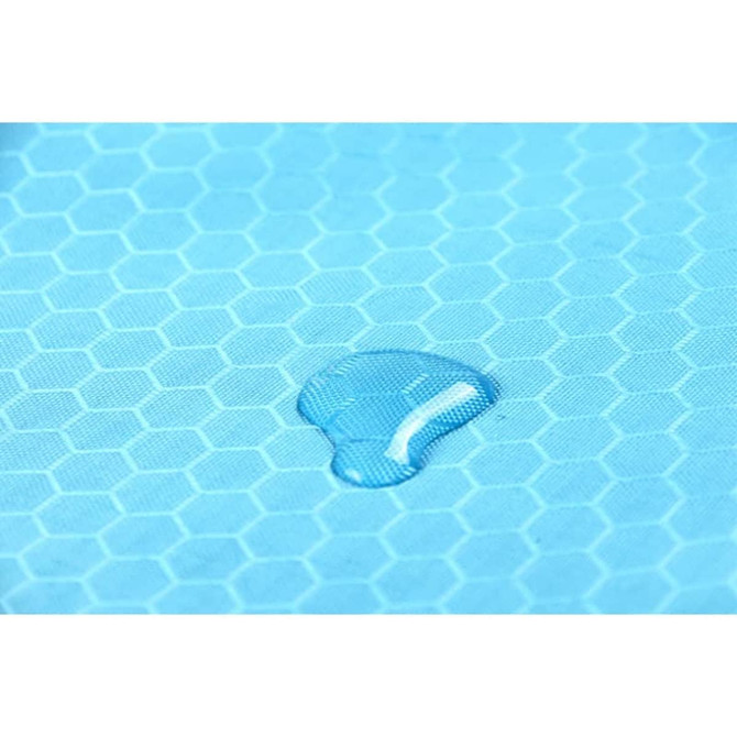 A close-up of a light blue fabric featuring a hexagonal pattern with a droplet of water on its surface.