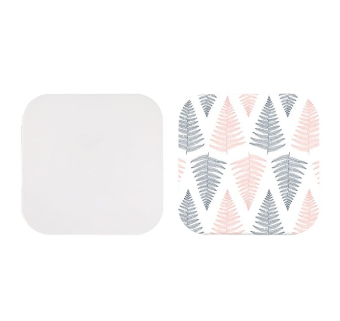 A square-shaped wireless charger with a plain white side and a patterned side featuring pink and grey fern leaves. A square-shaped wireless charger with a plain white side and a patterned side featuring pink and grey fern leaves.