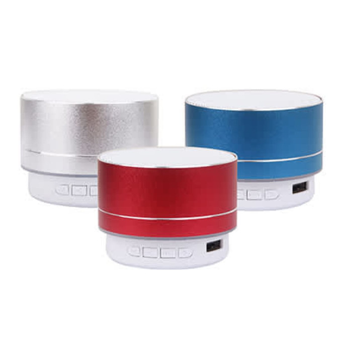 Three compact Bluetooth speakers in silver, red, and blue, featuring control buttons and a branding logo.
