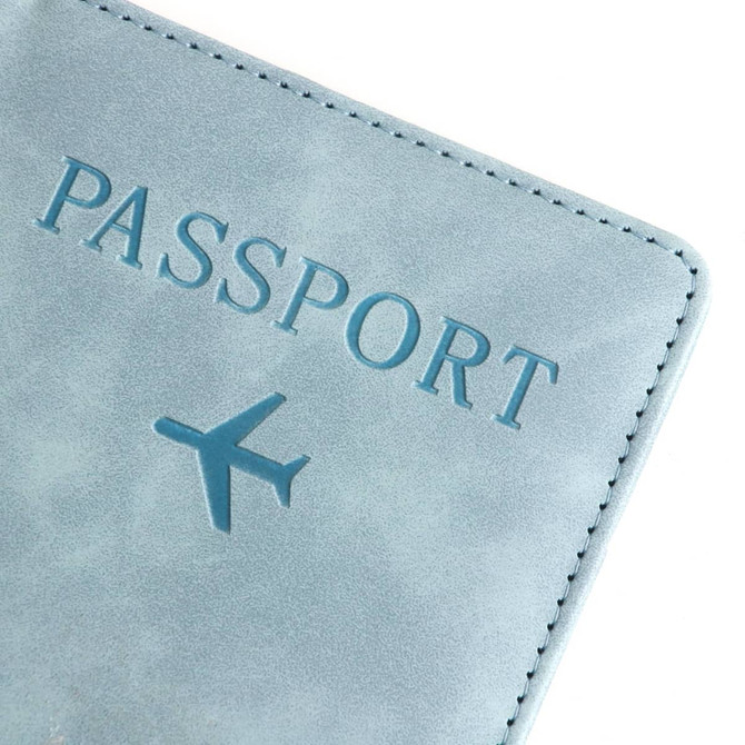 A blue PU leather passport holder with embossed text and an airplane graphic. It features a logo.