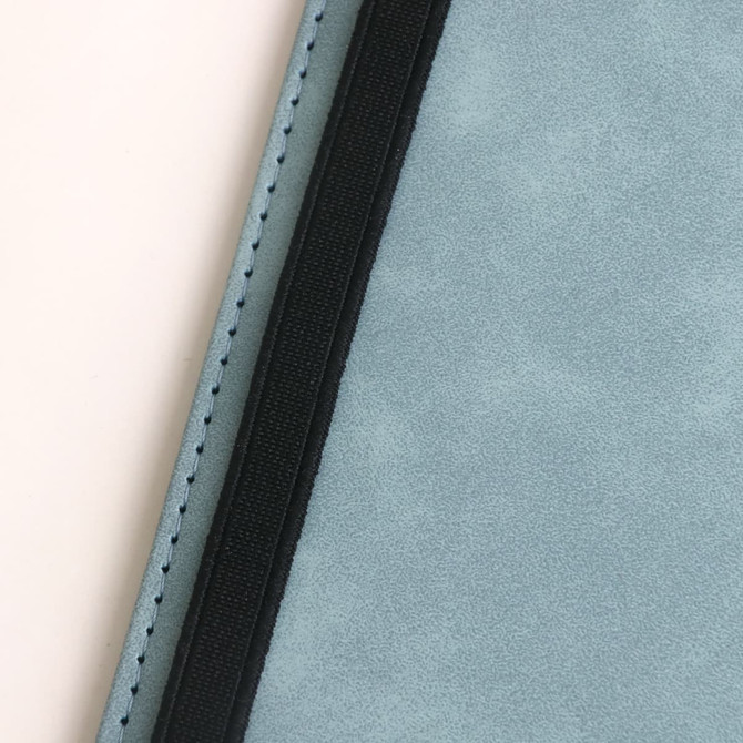 A passport holder in light blue PU leather with black stitching and a zipper closure, featuring a subtle logo.