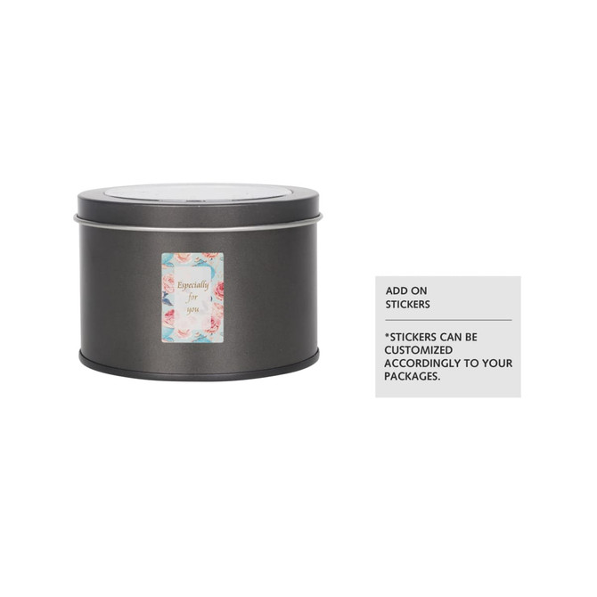 A medium grey tin can with a transparent window, featuring a decorative label and a logo. A medium grey tin can with a transparent window, featuring a decorative label and a logo.