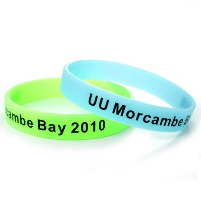 A set of glow-in-the-dark silicon wristbands in green and blue, featuring a logo and text. A set of glow-in-the-dark silicon wristbands in green and blue, featuring a logo and text.