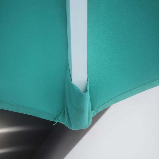 A green umbrella featuring a valance, showcasing its structure and pole connection. It has a branding logo visible.