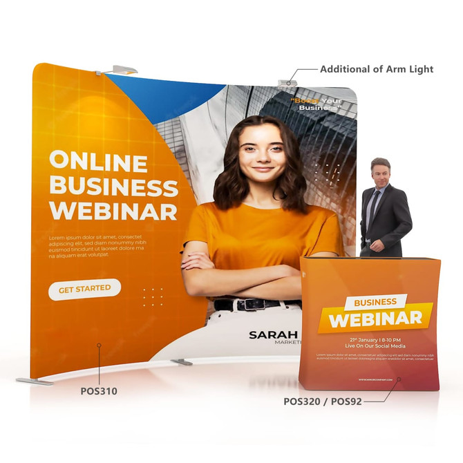 A C-shaped tension fabric display wall in orange and white with a model, promotional text, and a logo. A C-shaped tension fabric display wall in orange and white with a model, promotional text, and a logo.