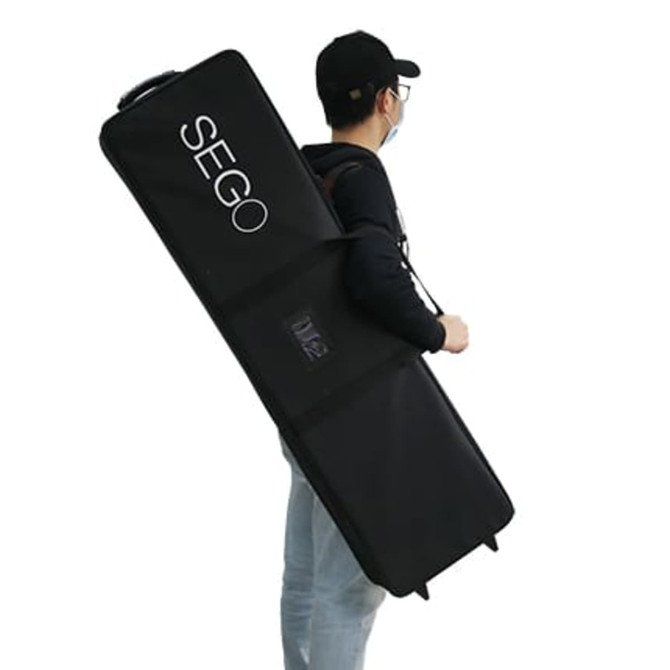 A person carries a large black carrying bag with a logo, designed for transporting a display.