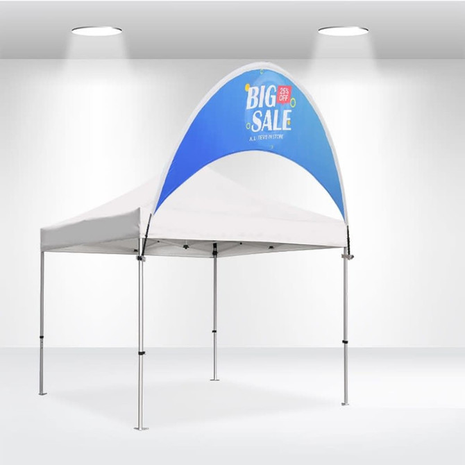 A curved tent billboard banner in blue and white, featuring a logo, set up in an indoor space with white walls.