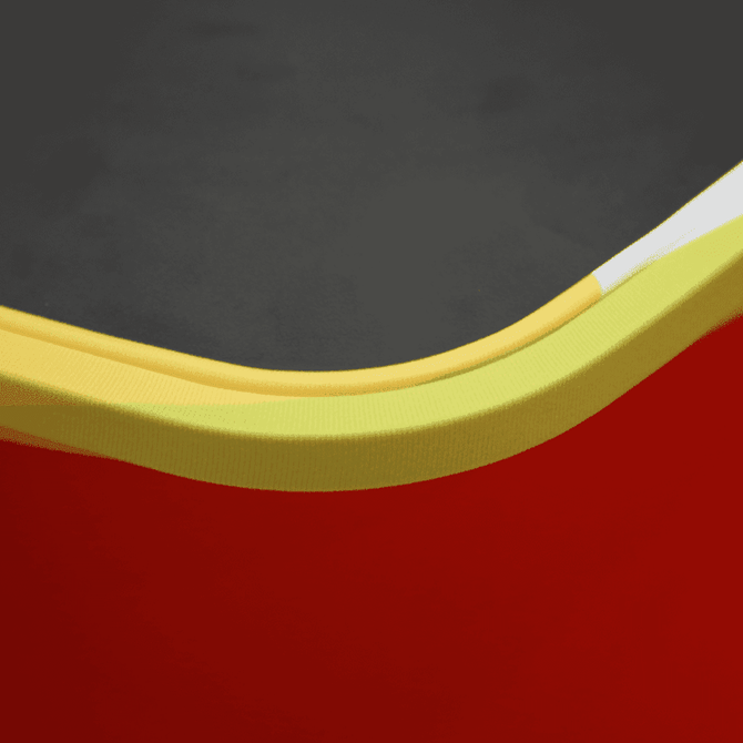 A close-up of a Square Popup Booth featuring a black top with yellow and white edges, and a vibrant red base. A close-up of a Square Popup Booth featuring a black top with yellow and white edges, and a vibrant red base.