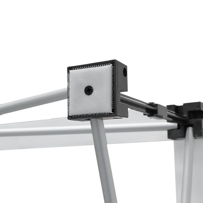 A close-up of a fabric popup display frame, featuring grey metal components and a textured connector.