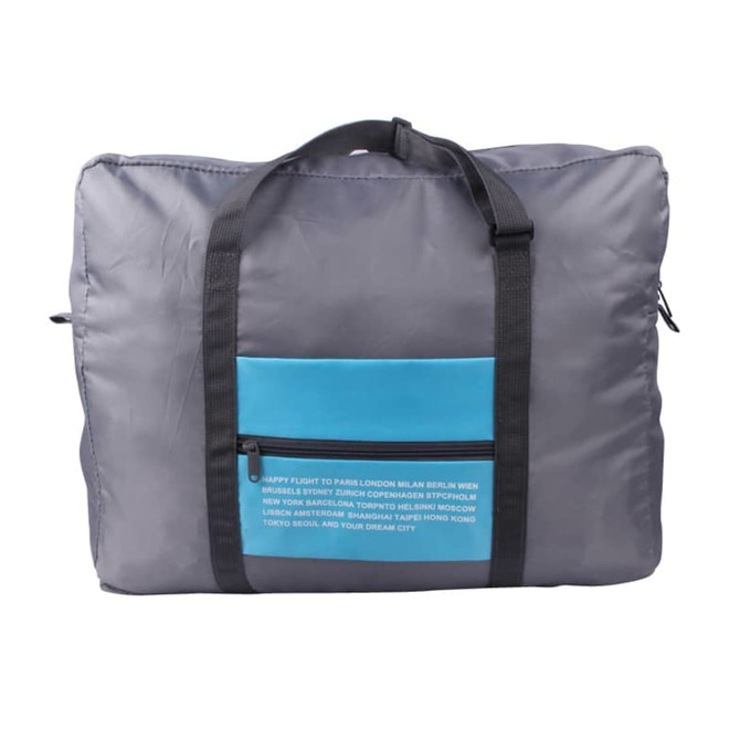 A grey travel compressed bag featuring a blue front pocket and black straps, with a logo on the side.