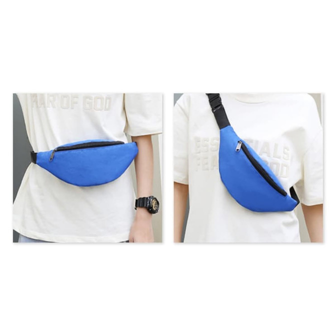 A blue bum bag with a zippered compartment, worn across the waist or over the shoulder. It has a black adjustable strap. A blue bum bag with a zippered compartment, worn across the waist or over the shoulder. It has a black adjustable strap.