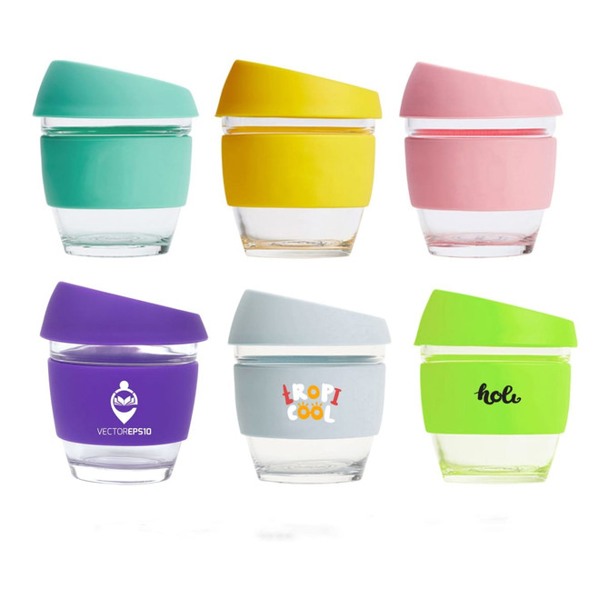 A collection of six reusable glass coffee cups in various colours: teal, yellow, pink, purple, grey, and white, each with a silicone lid.