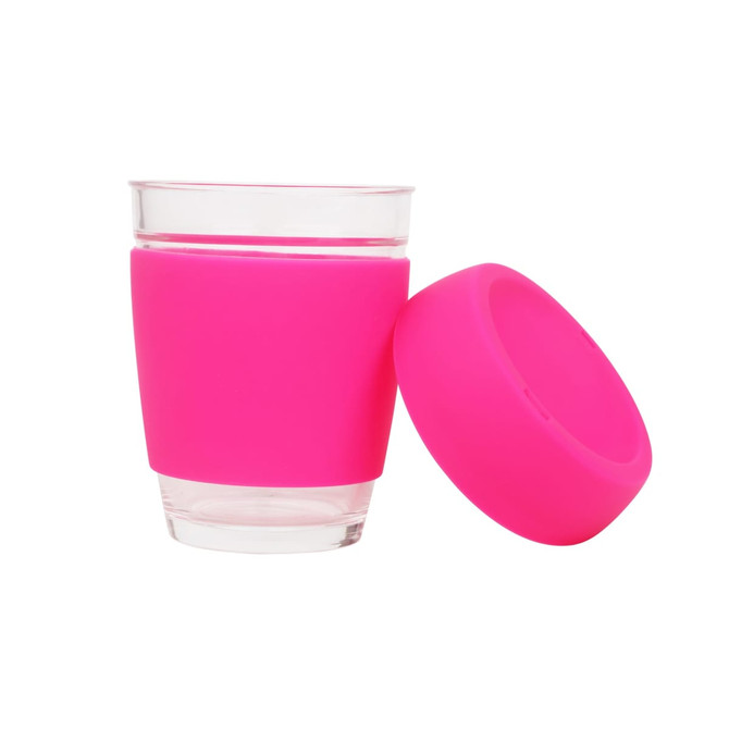 A reusable glass coffee cup with a transparent glass body and a bright pink silicone sleeve.