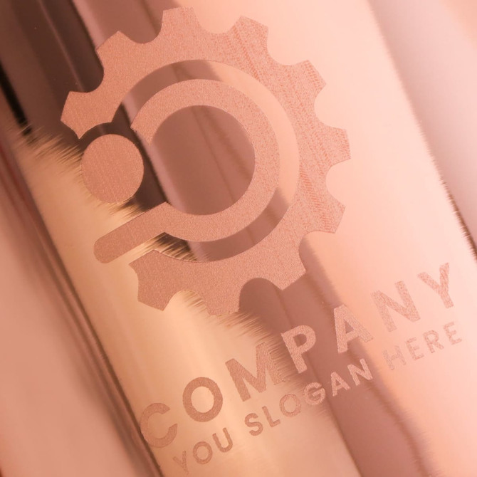 A copper mug with a metallic finish, featuring a logo and text engravings.