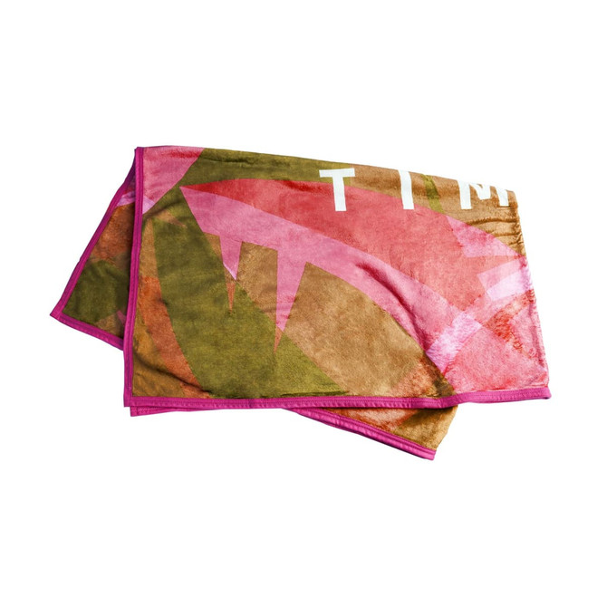 A flannel blanket featuring a colourful design with shades of pink, green, and brown, bordered with pink.