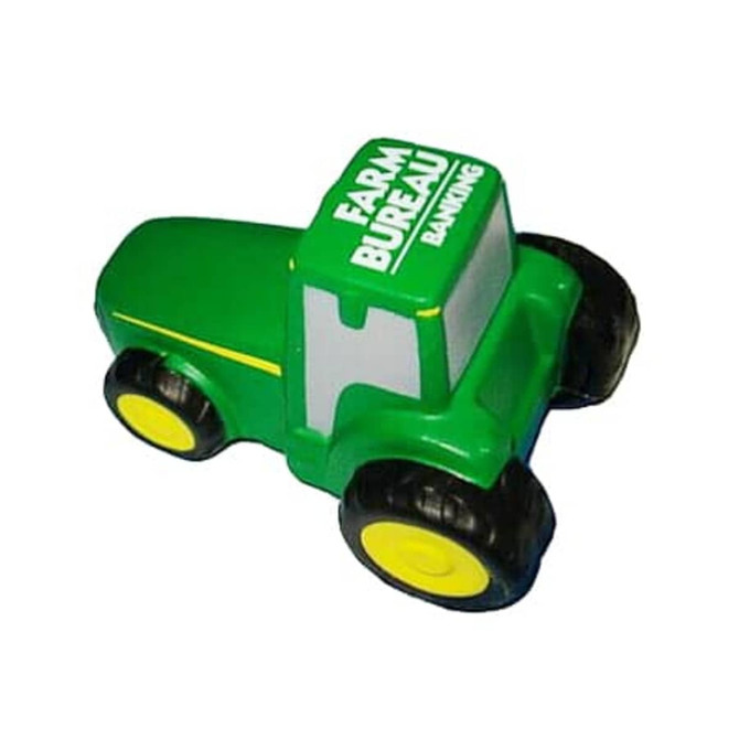 A green tractor-shaped stress reliever with yellow wheels and a branding logo on top.