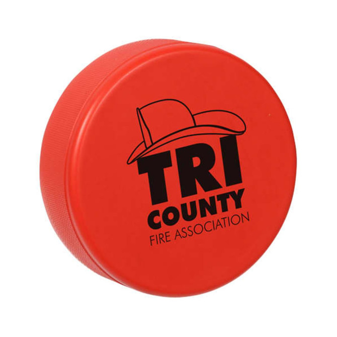 A red hockey puck-shaped stress reliever featuring a logo and a textured surface.
