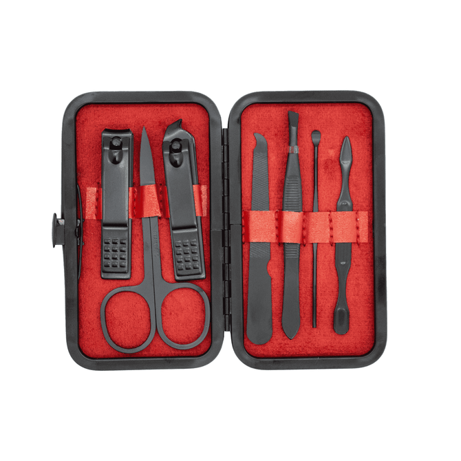 A black manicure set with red lining, featuring scissors, clippers, and various grooming tools in a compact case.