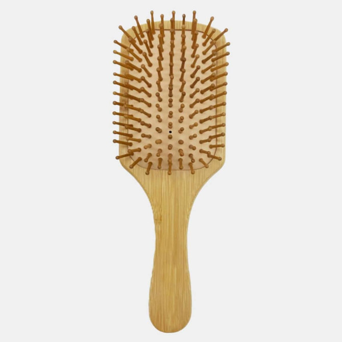 A bamboo hairbrush with a wooden handle and bristles, featuring a rectangular paddle design.