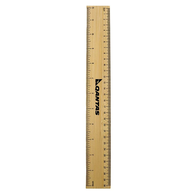 A bamboo ruler with black markings, featuring a logo, measuring 30 centimetres in length.