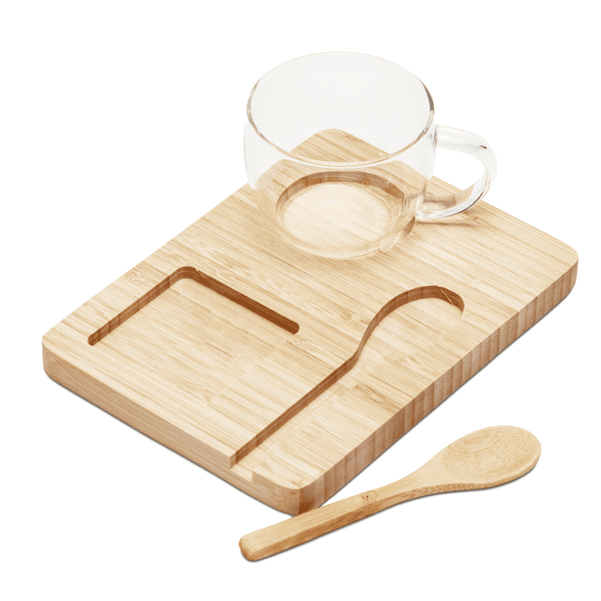 A bamboo tray with a clear glass cup and a wooden spoon. The set is minimalistic and natural in style.