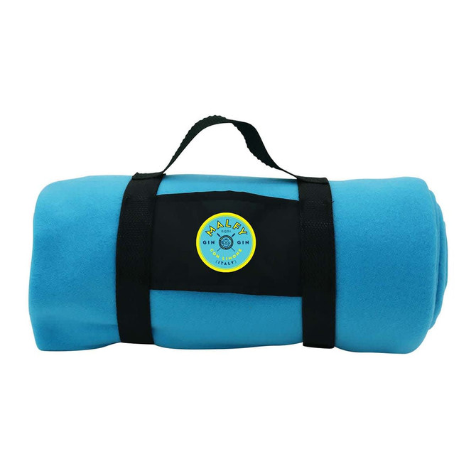 A rolled-up blue fleece blanket is secured with a black strap and features a circular logo.